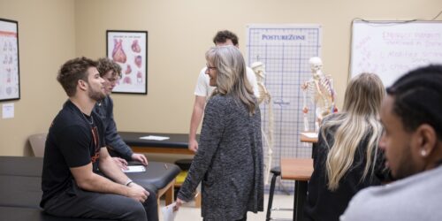 professor works with student sin kinesiology lab